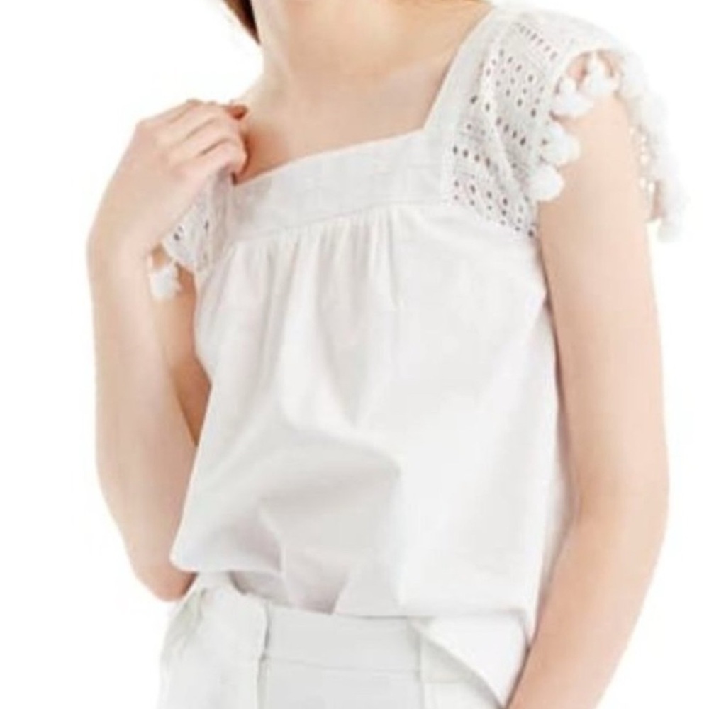 J.Crew eyelette top with pom pom trip in white, size 2. Excellent condition.